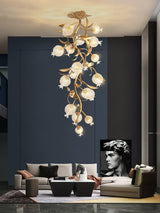 Brass branch chandelier in a dark blue living room with a bust