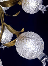 Close view of the brass leaves and two frosted glass globes
