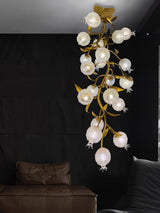 Brass branch chandelier in a dark bedroom beside a window