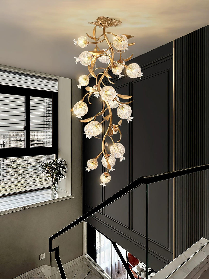 Brass branch chandelier in a stairwell beside a tall window