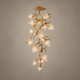 Brass branch chandelier seen full length against a beige background