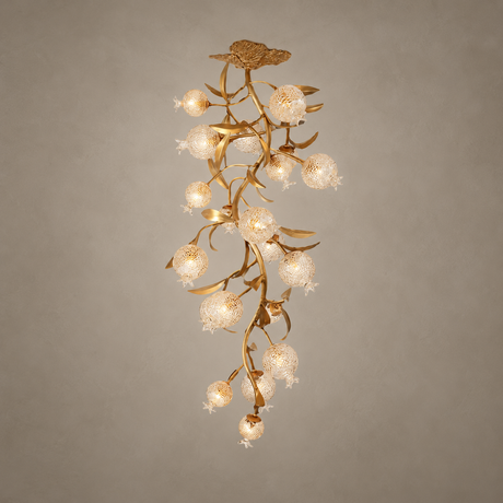 Brass branch chandelier seen full length against a beige background