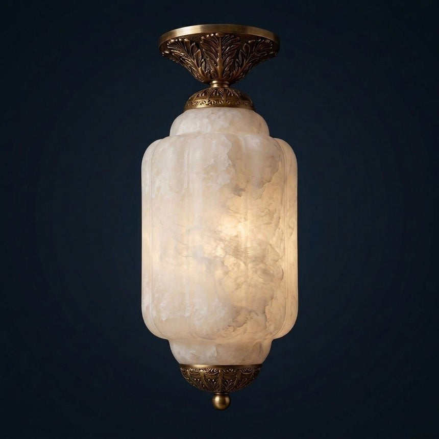 Antique brass stone ceiling light lit against a dark blue background