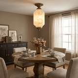 Antique brass stone ceiling light above a dining table with a dark sideboard