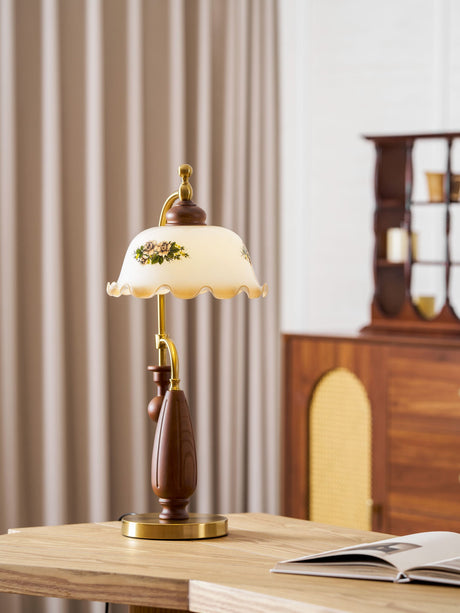 Antique brass table lamp lit beside a glazed wood cabinet