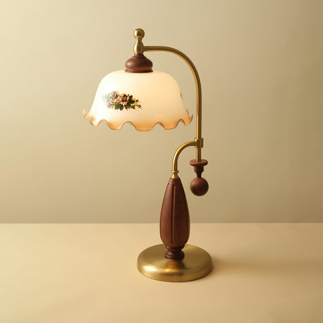 Antique brass table lamp lit against a plain warm ground