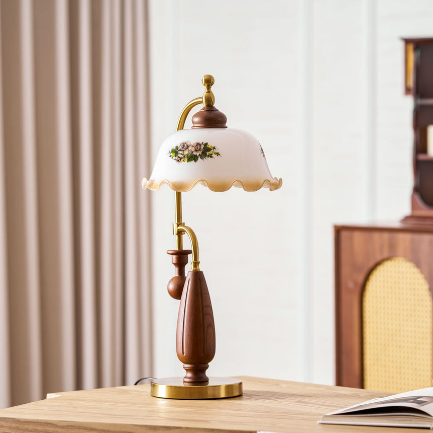 Antique brass table lamp lit on a console in front of a cabinet