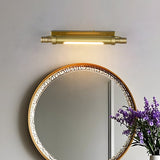 Brass tube lit above a beaded round mirror with lavender in a vase