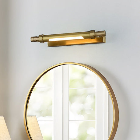 Brass tube lit above a round gold mirror reflecting a bright window