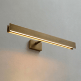 The brass bar lit at an angle, the light strip running along its lower face