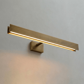 The brass bar lit at an angle, the light strip running along its lower face