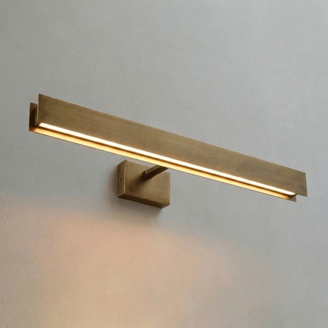 The brass bar lit at an angle, the light strip running along its lower face