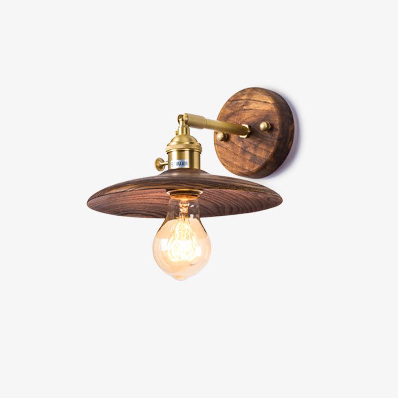 Flared walnut shade on a brass arm seen from a slight angle, lit