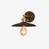 Detail of the wide flared walnut shade and the brass socket below it