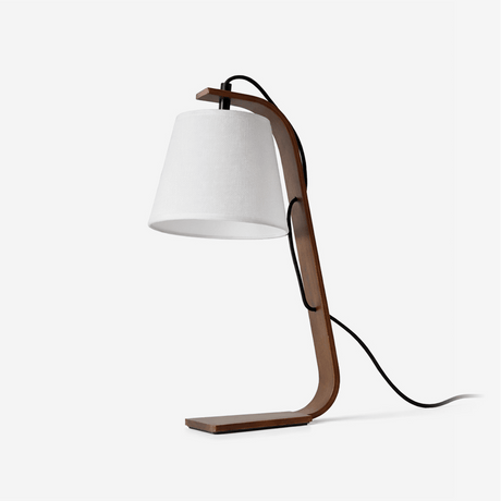 Table lamp with a curved bentwood arm carrying a small tapered shade