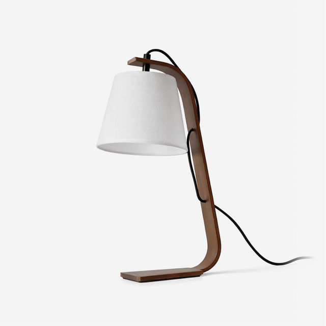Table lamp with a curved bentwood arm carrying a small tapered shade