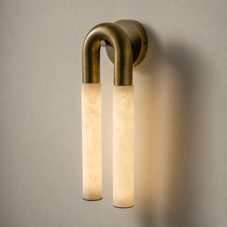 The lit sconce seen straight on, the two tubes glowing amber