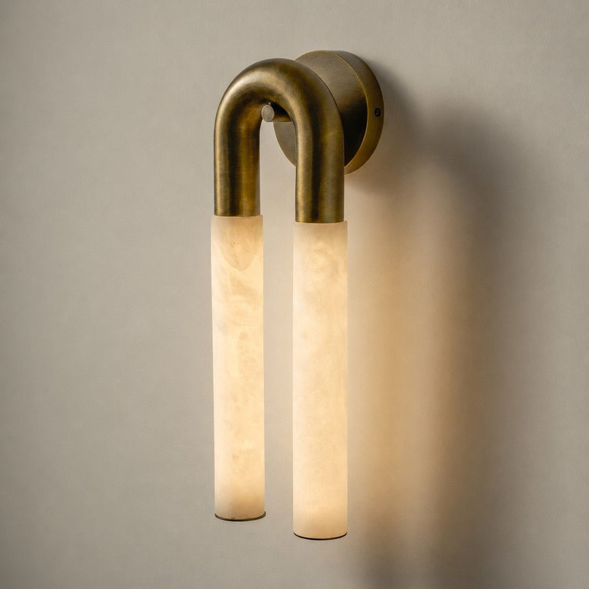 The lit sconce seen straight on, the two tubes glowing amber
