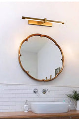 Brass twin bar above a scalloped mirror over a basin and a tiled wall
