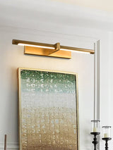 Brass twin bar lit over a green canvas beside tall black candlesticks