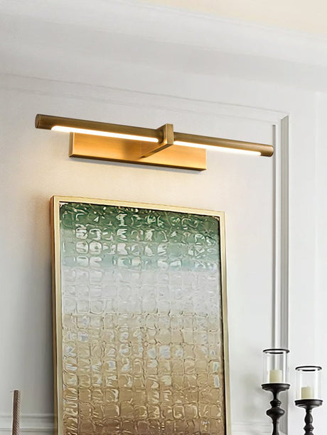 Brass twin bar lit over a green canvas beside tall black candlesticks