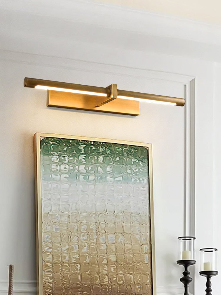 Brass twin bar lit over a green canvas beside tall black candlesticks
