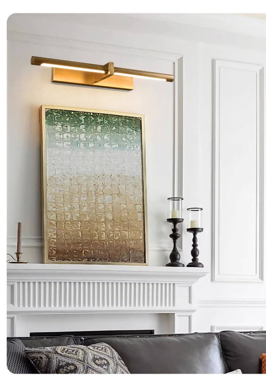 Brass twin bar lit above a green canvas over a mantel with candlesticks