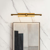 Brass twin bar lit above a framed artwork on a marble clad wall