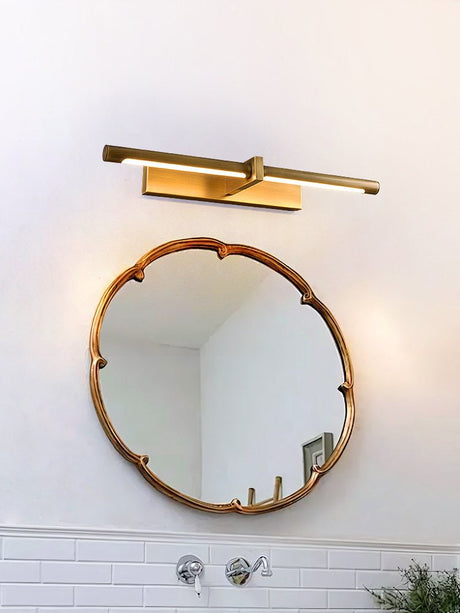 Brass twin bar above a scalloped round mirror in a tiled bathroom