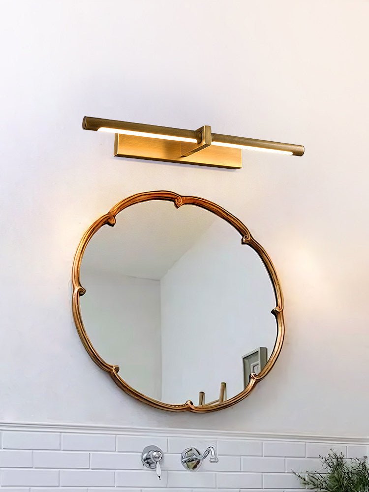 Brass twin bar above a scalloped round mirror in a tiled bathroom