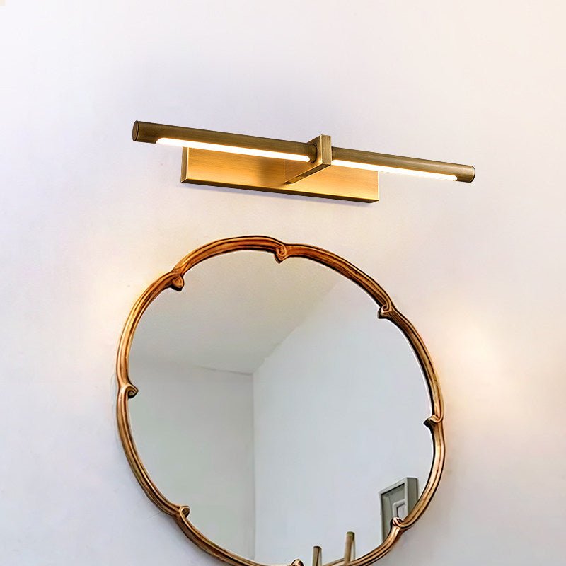 Brass twin bar lit above a scalloped round mirror on a white wall