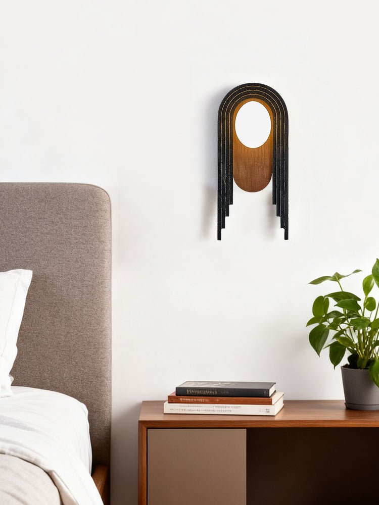 The arch lamp above a nightstand beside an upholstered headboard