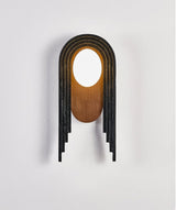 The lamp seen from the front, the stepped black bands around the walnut oval