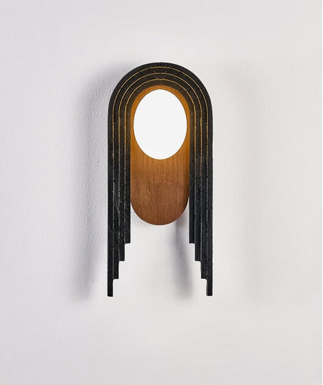 The lamp seen from the front, the stepped black bands around the walnut oval