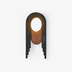 Stepped black arch wall lamp with a walnut oval and a white glass disc at the top