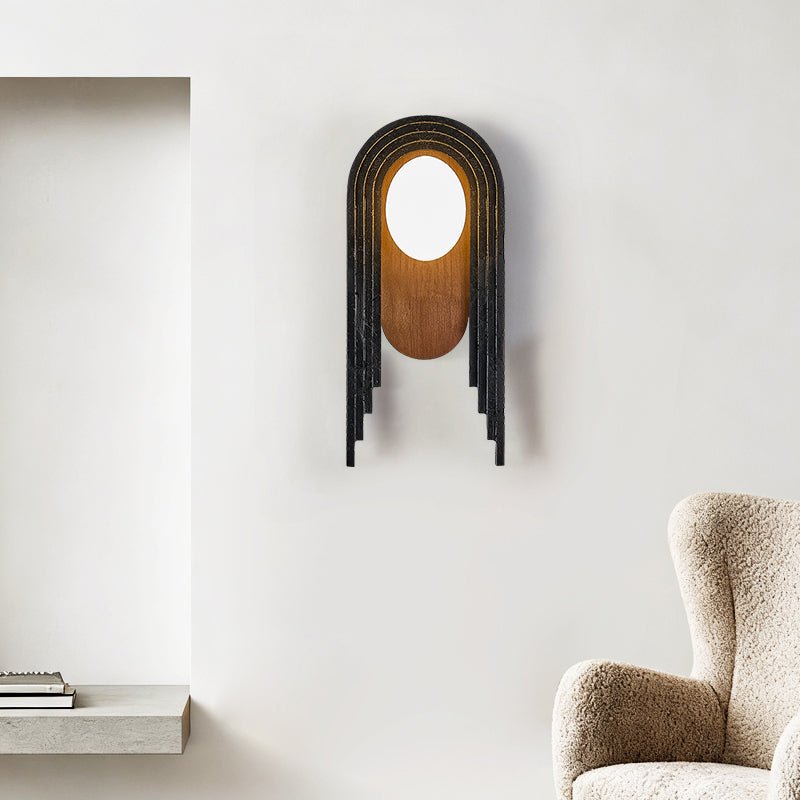 The arch lamp on a white wall beside a niche and the arm of a wool chair