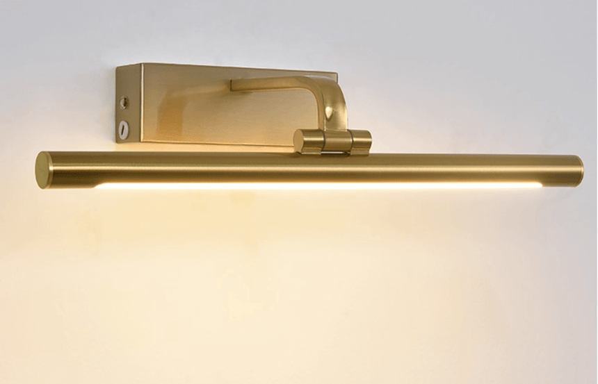 The gold tube on its frame arm seen at an angle, the mounting plate behind it