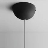 The black domed ceiling plate seen from below on a plain gray field