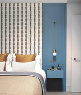 The ball light hanging in a blue niche beside a bed