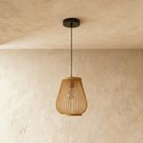 A tall narrow bamboo shade with the ribs drawn in toward the base