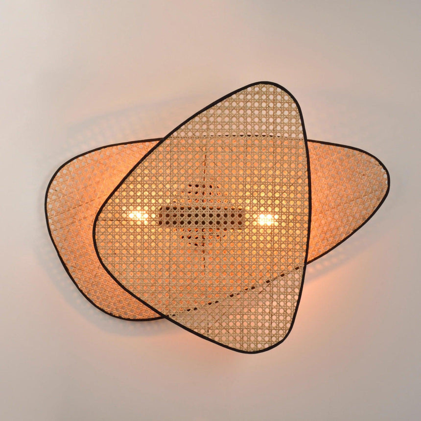 The overlapping cane screens lit warm, light falling through the open weave