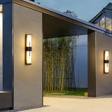 The light beside a covered gateway that opens onto a bamboo garden