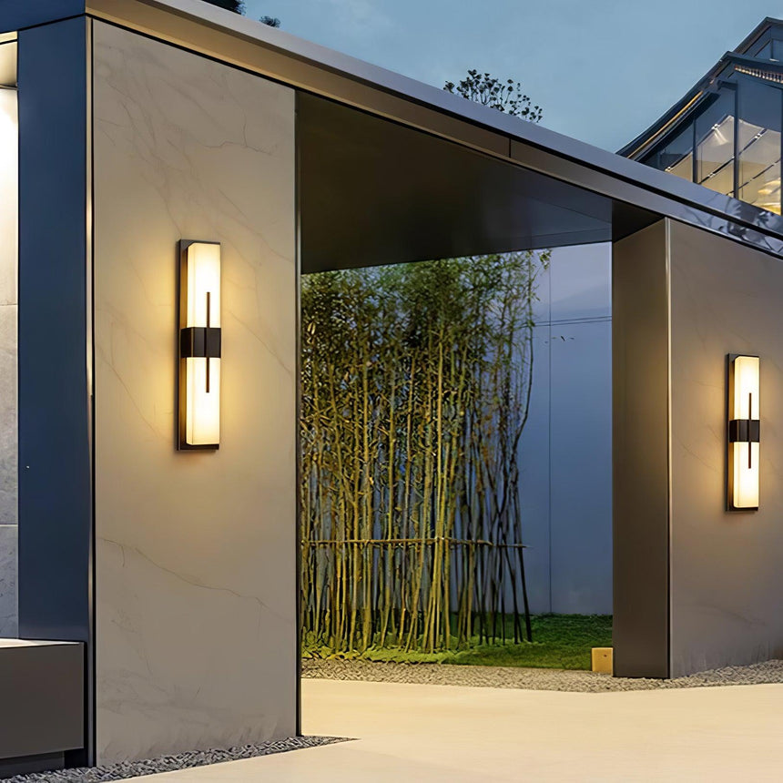 The light beside a covered gateway that opens onto a bamboo garden