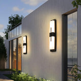 Bar lights spaced along the long white wall of a modern house beside tall glass