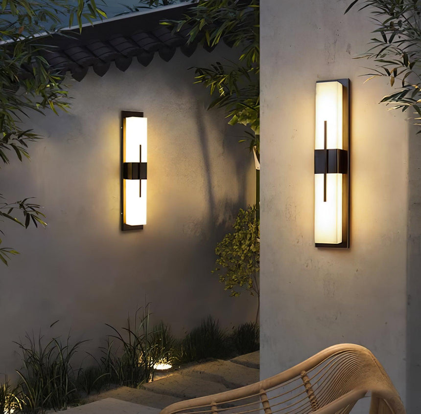 Two bar lights on courtyard walls either side of stone steps, a rattan chair nearby