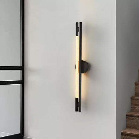 The lit bar on a gray wall beside a staircase and a dark door frame