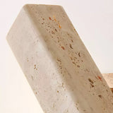 Close view of the pitted face of the travertine bar