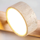 Minimalist close view of one travertine disc lit, the stone rim glowing at the edge