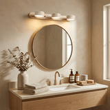 Travertine bar lit above a round mirror over a stone bathroom vanity