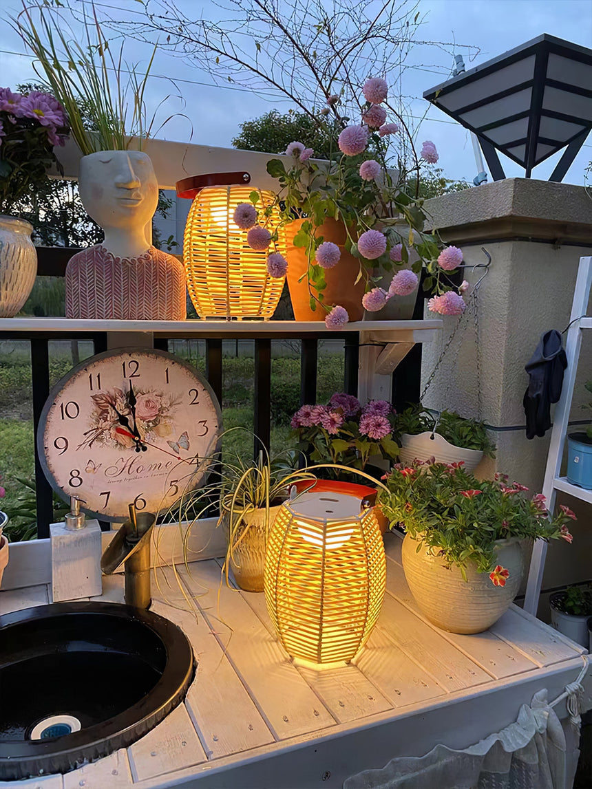 Two lit among potted flowers and a clock on a planted balcony